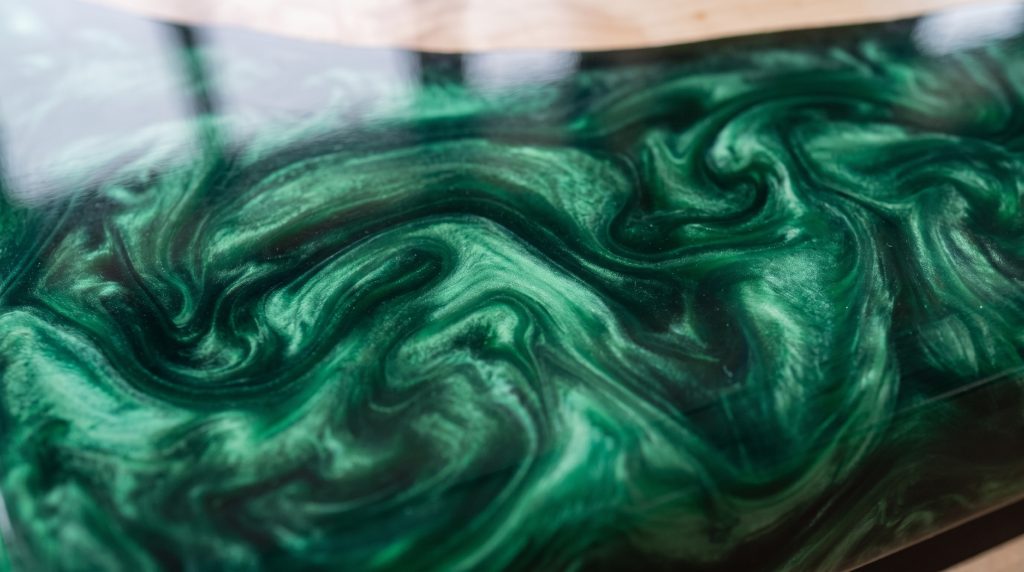 Emerald swirl: Marbled green resin with dark swirls and glossy depth.