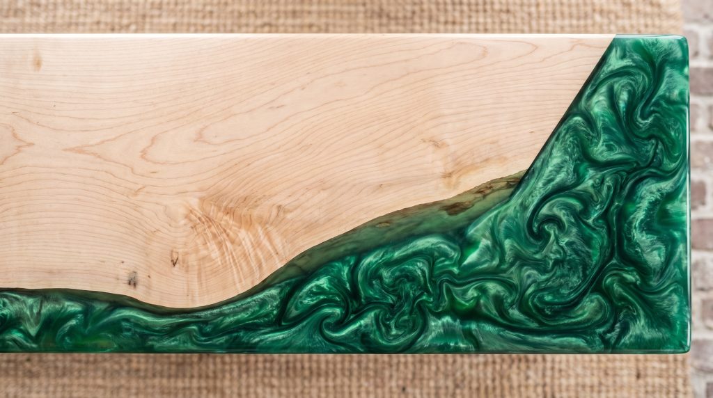Wood meets resin: Pale grain meeting the green resin along the live edge.