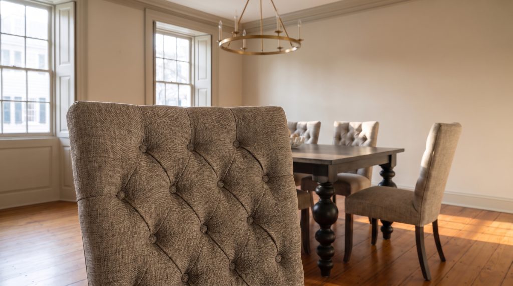 Button tufting: Diamond tufting in an oatmeal-gray tweed.