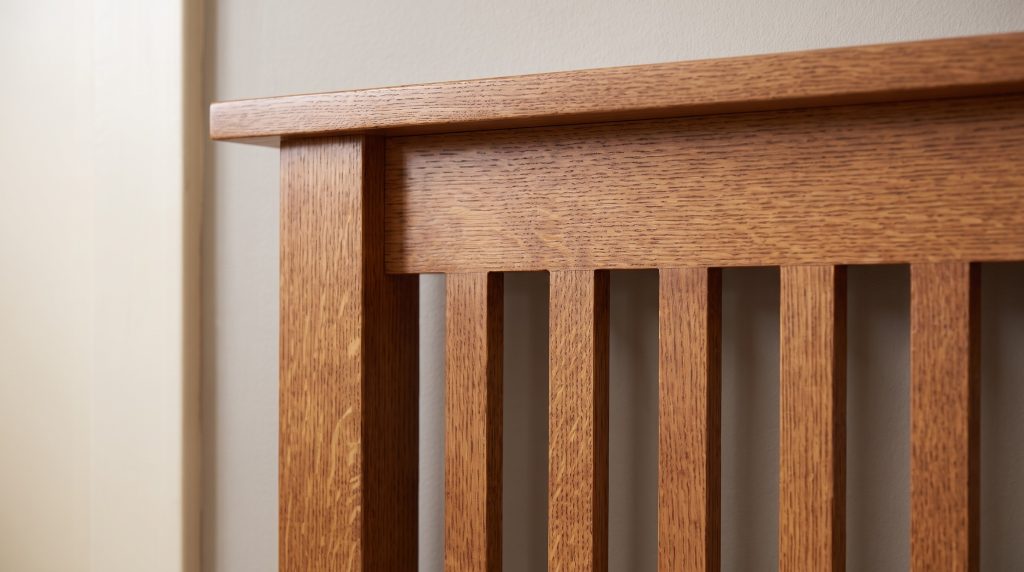 Slats under the rail: Quartersawn oak slats with ray fleck meeting the flat top rail.