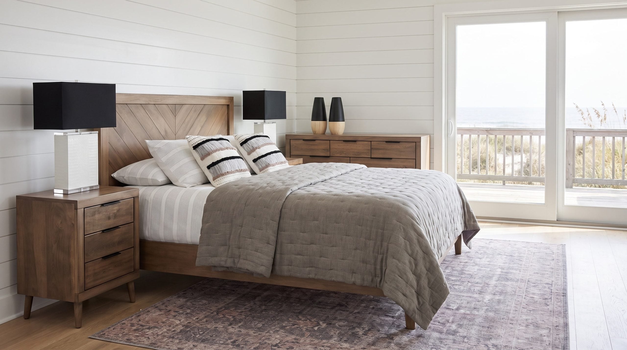 An oak bed with a diagonal chevron headboard, a three-drawer nightstand and a six-drawer dresser on tapered legs, in an Isle of Palms beachfront bedroom.