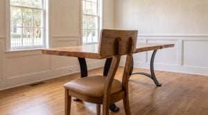 The dining chair: A flat backrest block bolted to two curving stiles.