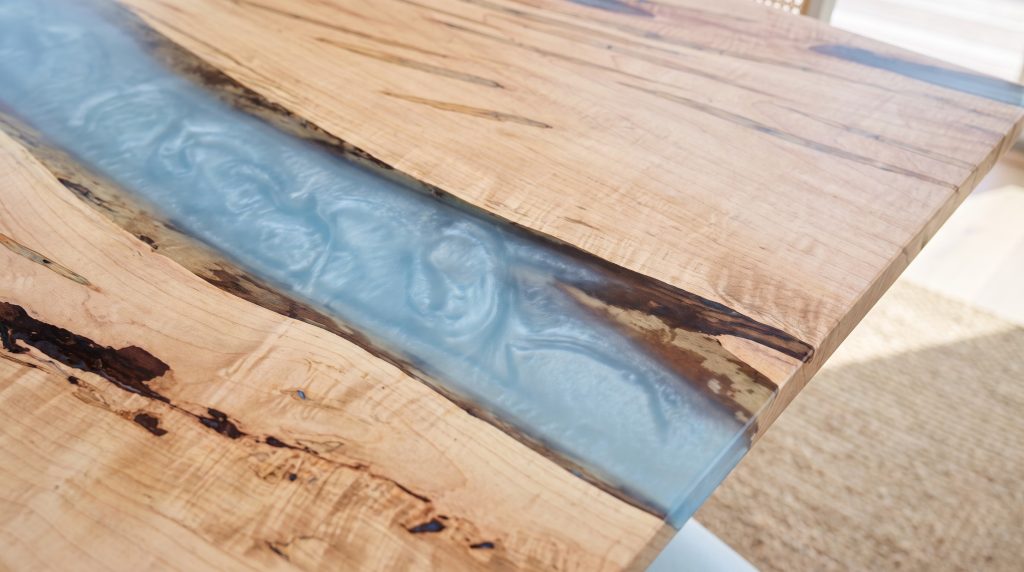 The rippled river: Pale blue resin with a wave texture beside a spalted edge.