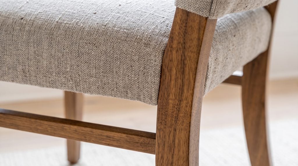 Tweed and walnut: The flecked tweed seat over a walnut leg and stretcher.
