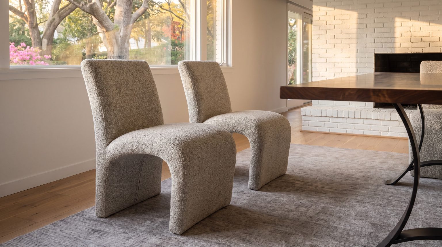 The sculpted chairs: Boucle shells that roll from the back down to the floor.