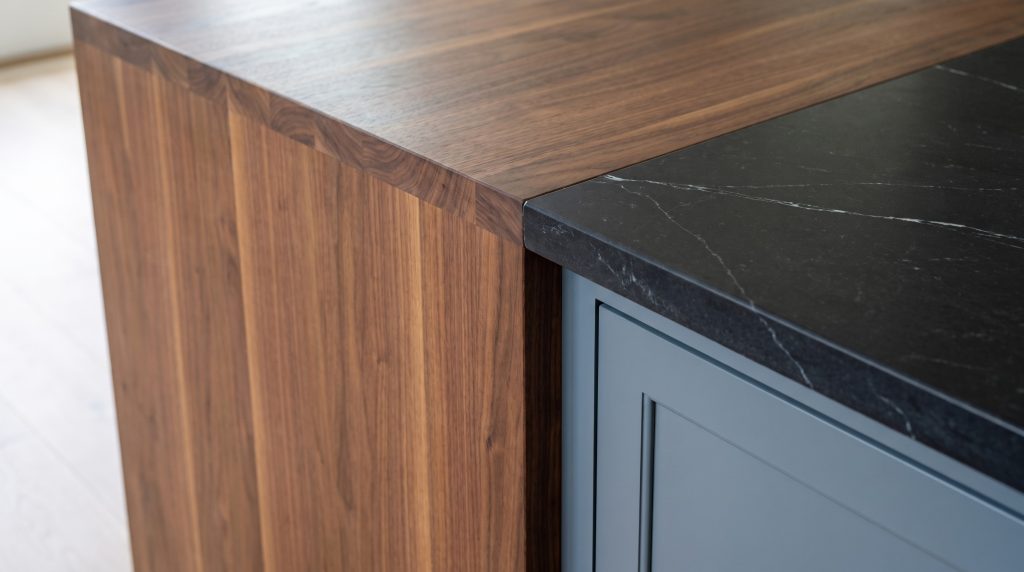 Walnut on stone: The walnut end block meeting the black top and slate paint.