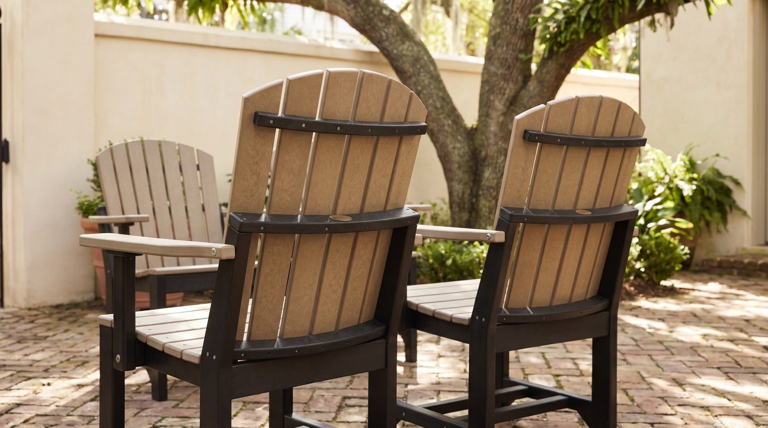 The armchair: Five tan slats on a black frame and arms.