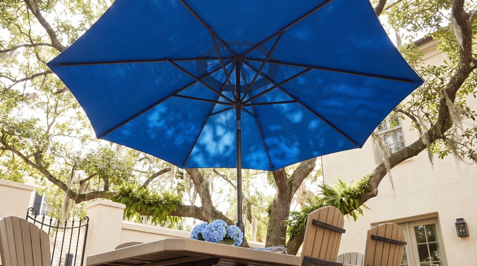 The umbrella: Cobalt canvas over the table on a dark pole.