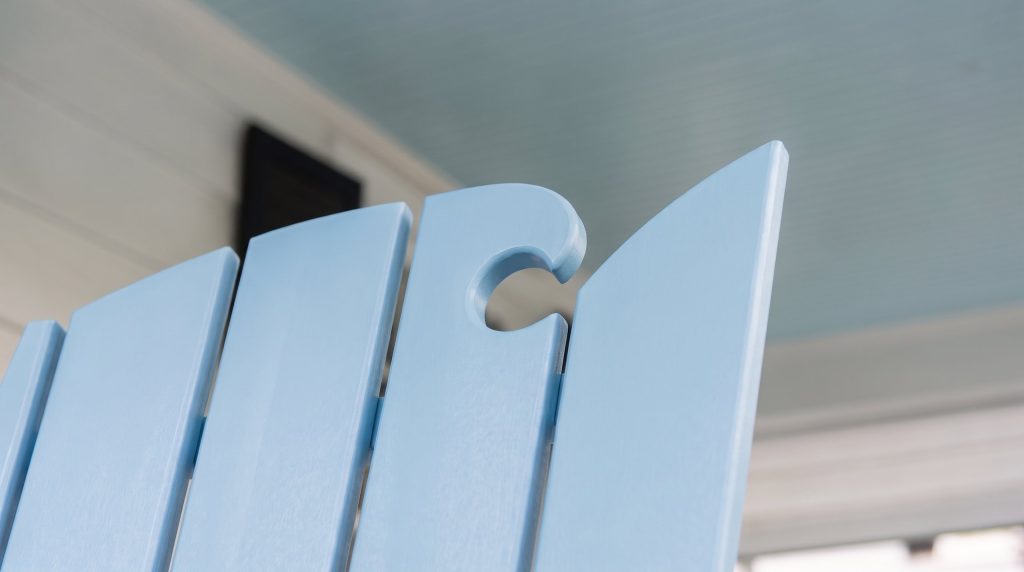 Sky blue on white: close-up of solid poly lumber fan-back slats in sky blue, with the keyhole cut-out at the top of the back.
