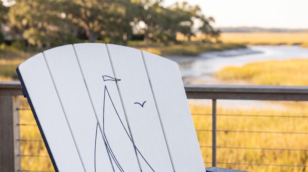 The sailboat: The navy line drawing on a white chair back.