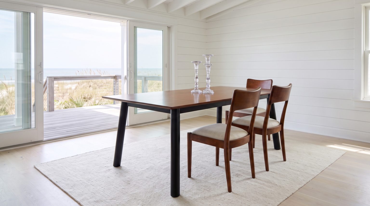 The cherry top on round black legs, with two Avocet chairs on the far side.
