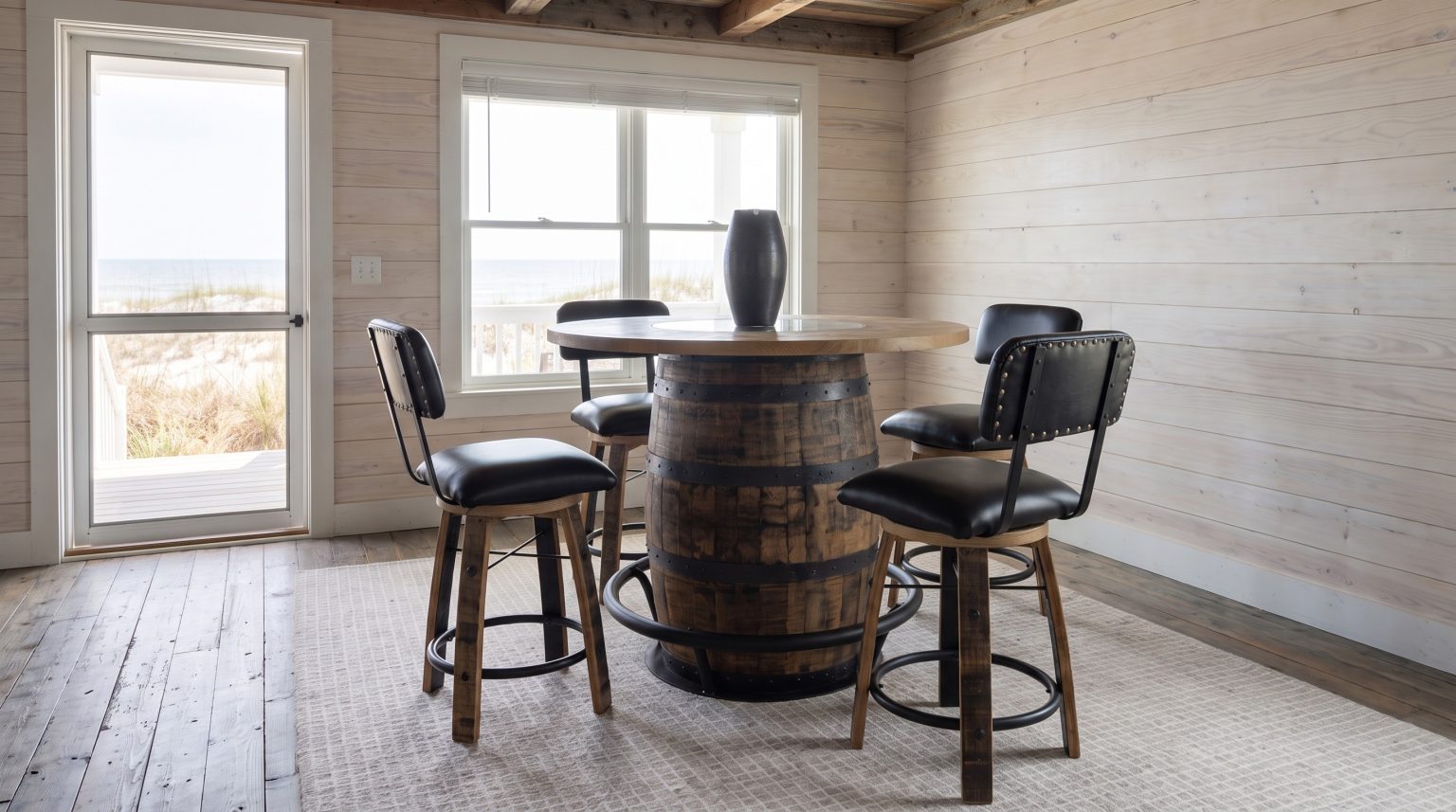 The pub table with two stools tucked in, the dunes beyond the window.