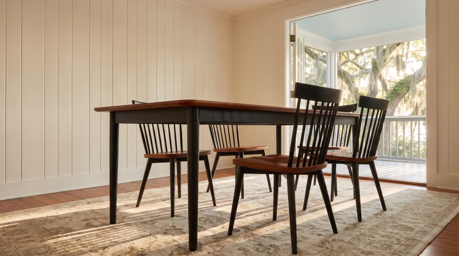 The table corner from low down: black skirt and slim tapered legs.