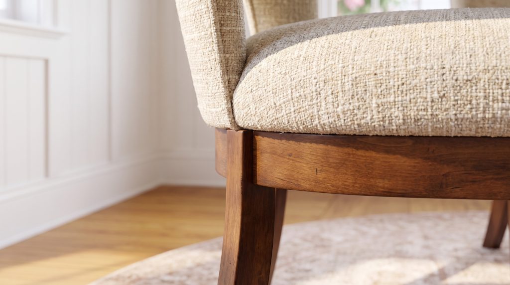 A close view of oatmeal tweed upholstery above a tavern maple seat rail and leg