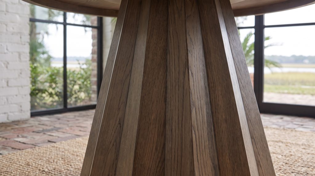 A close view of angled white oak staves forming a faceted table pedestal
