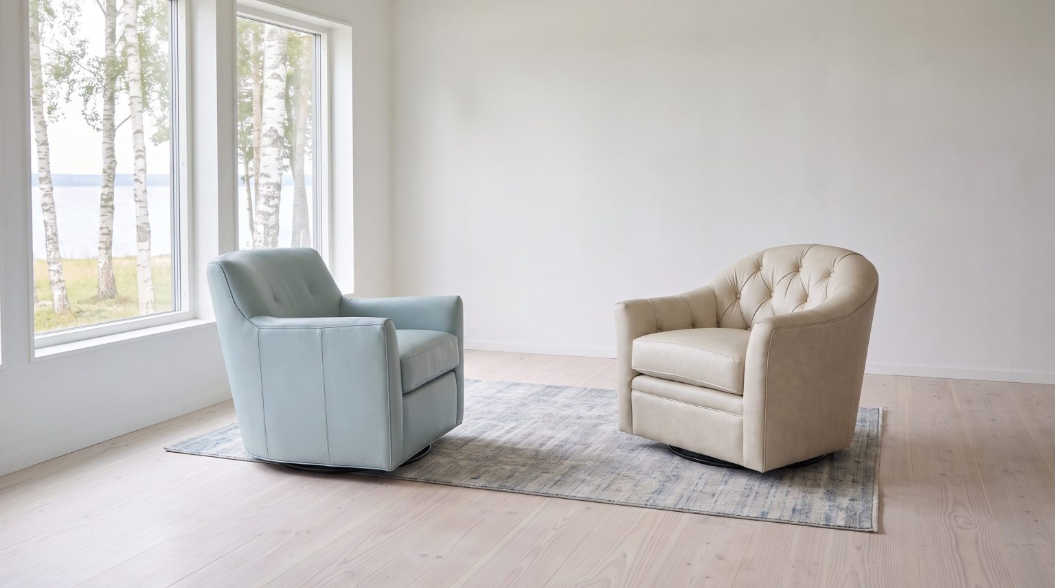 A light blue leather swivel chair facing a cream tufted barrel chair on a pale rug by tall windows