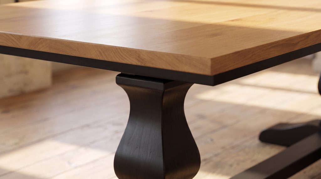 Close-up of the oak table top meeting the shaped black painted pedestal beneath it