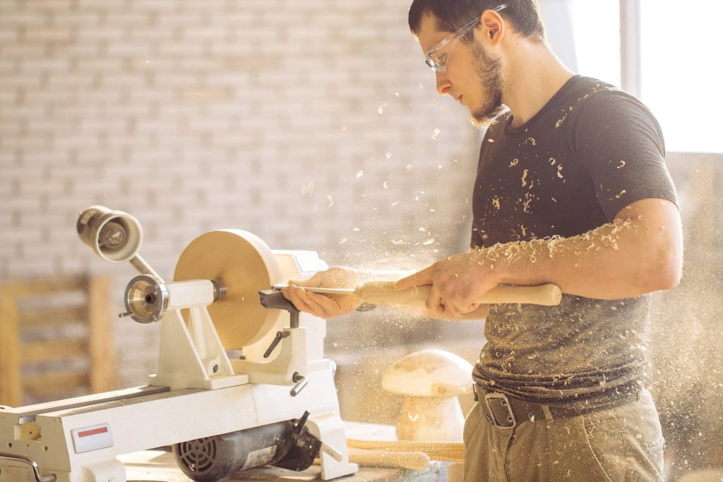 An Amish craftsman making furniture in a wood shop