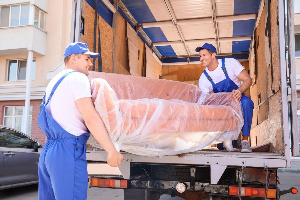 A sofa being carefully lifted off the delivery truck