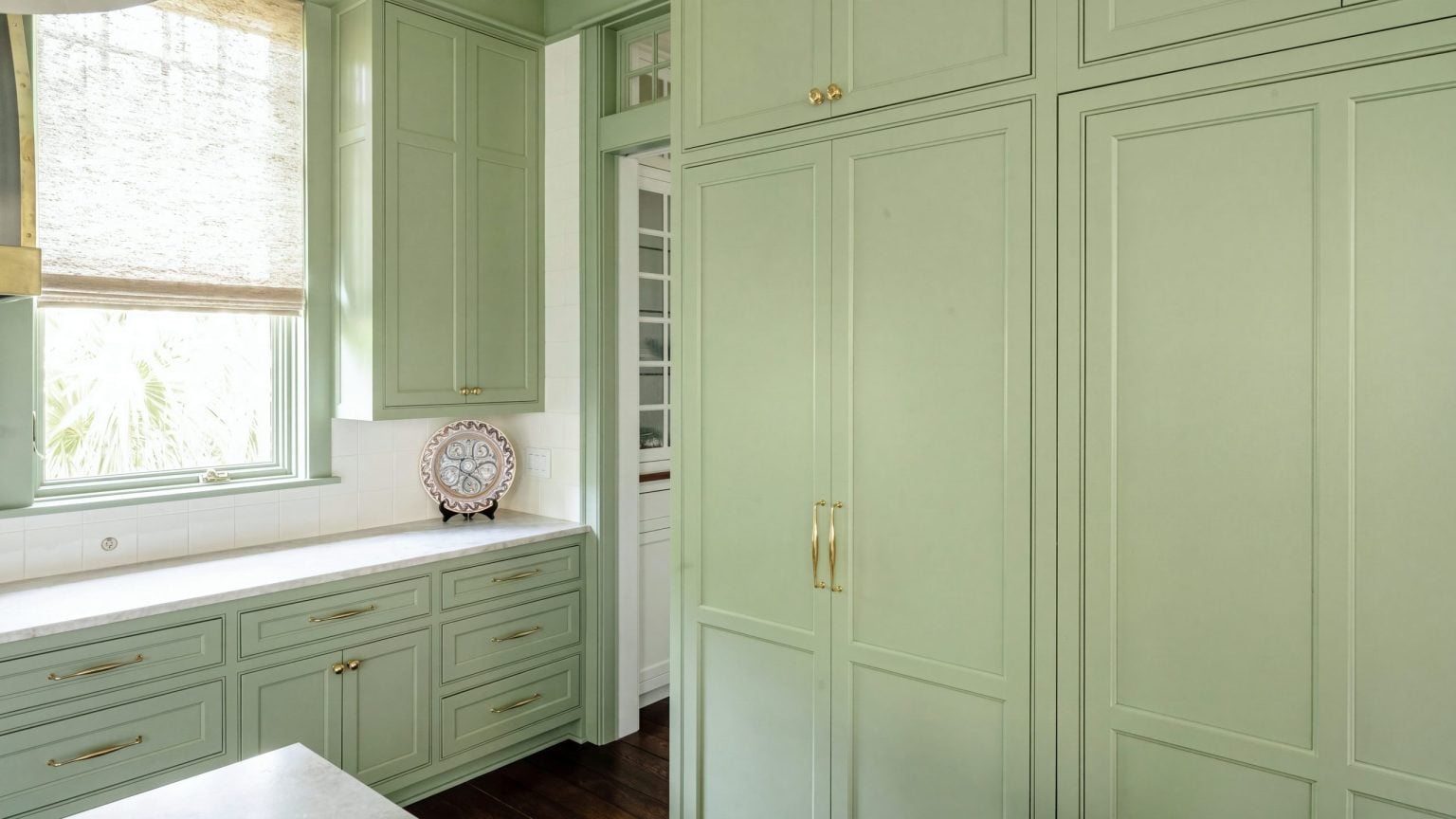 Pantry wall: Tall paneled doors in two tiers, carried straight into the crown.