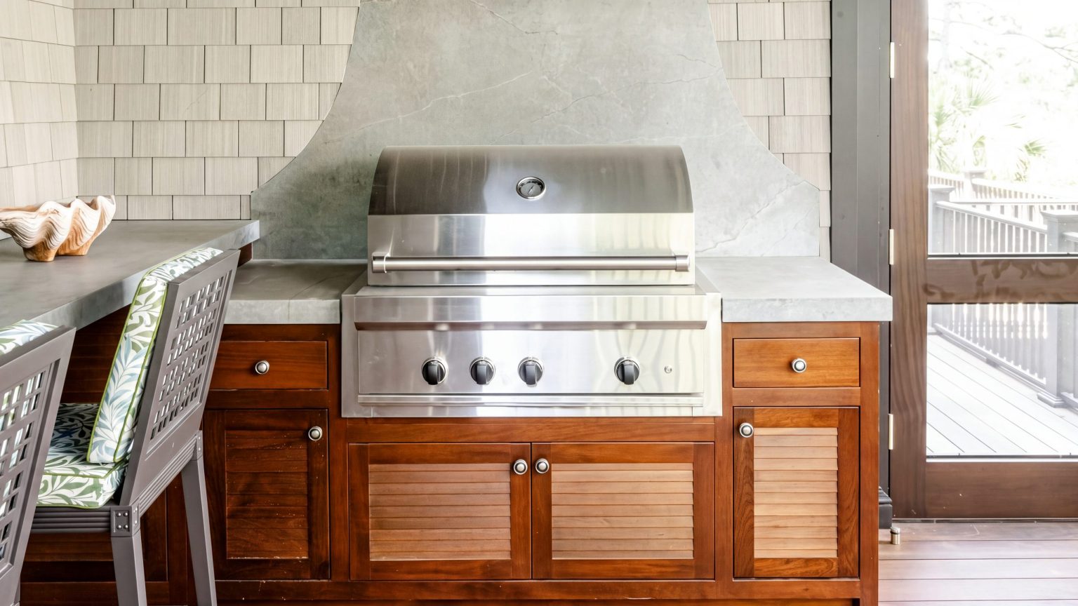 Grill run and stools: The mahogany run beside a soapstone bar with two lattice-back stools.