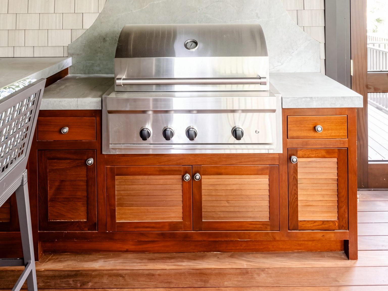 Louvered base: Louvered doors under the grill, raised-panel doors and drawers either side.