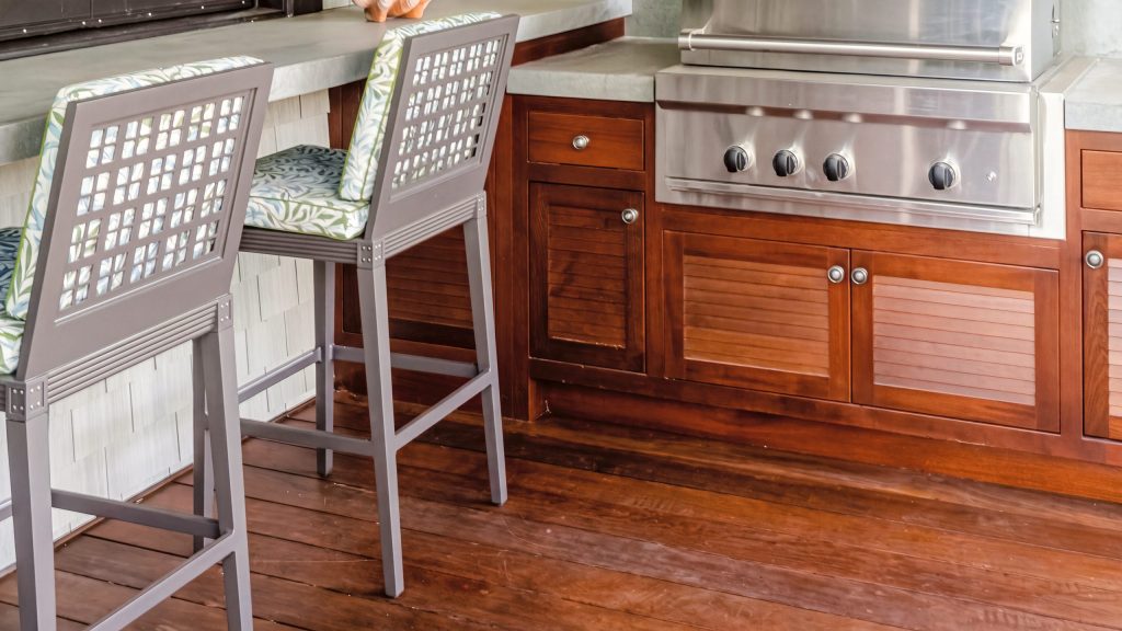 Side run: A drawer and louvered door at the end of the run, beside the bar stools.