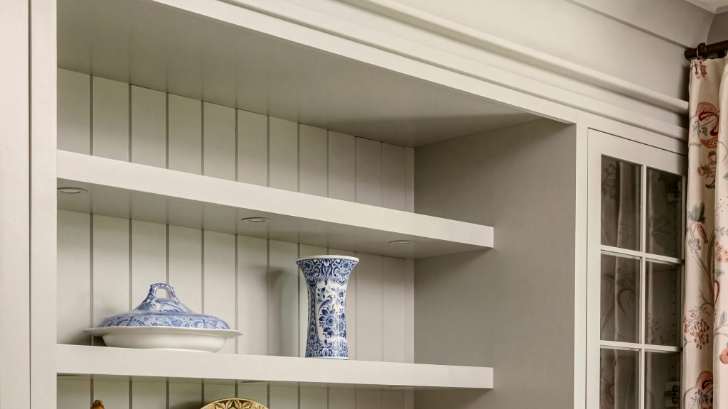 Beadboard shelving: Thick painted shelves against a vertical beadboard back.