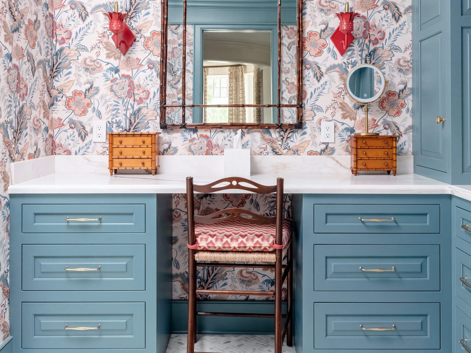 Makeup station: A knee space and rush-seat chair between two drawer banks.