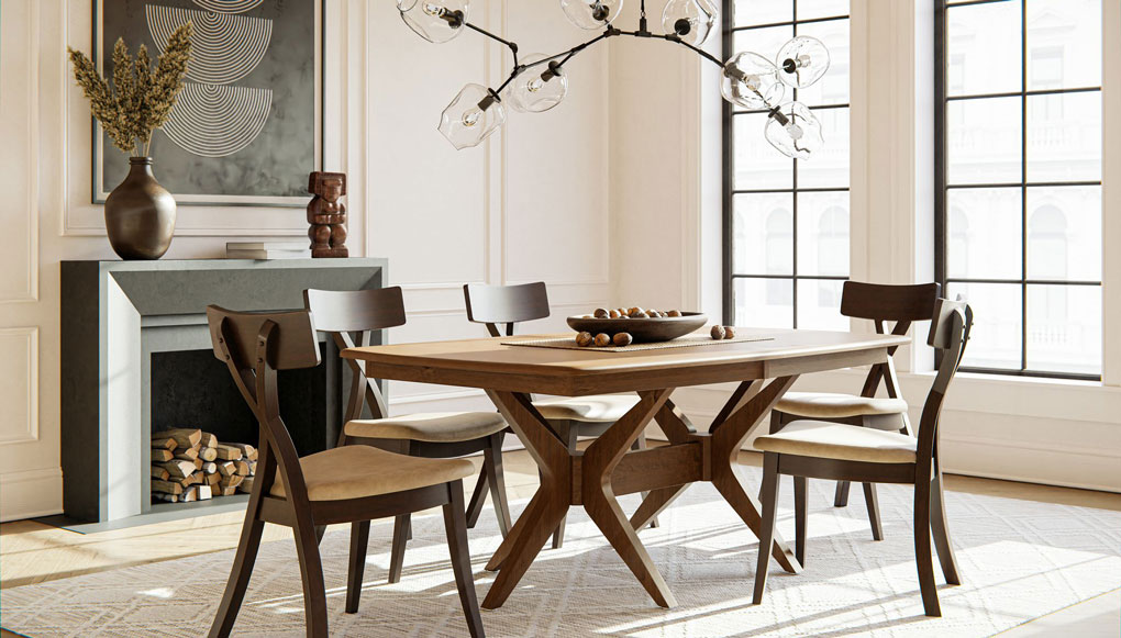 A long hardwood trestle dining table in a white room with a branch chandelier