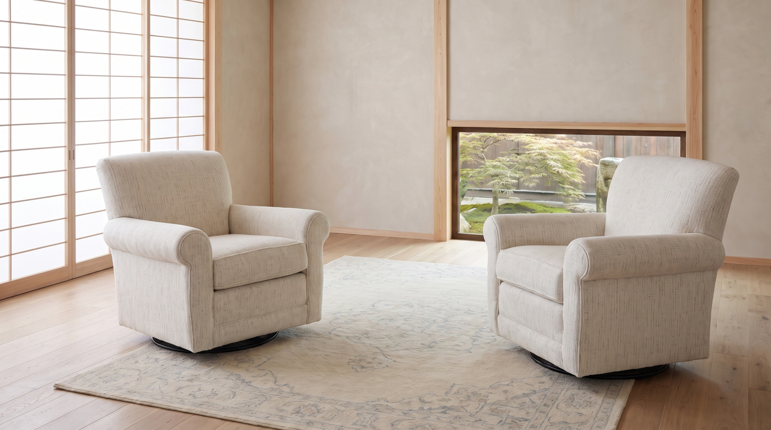 A pair of cream upholstered swivel glider chairs facing into the room on a pale rug