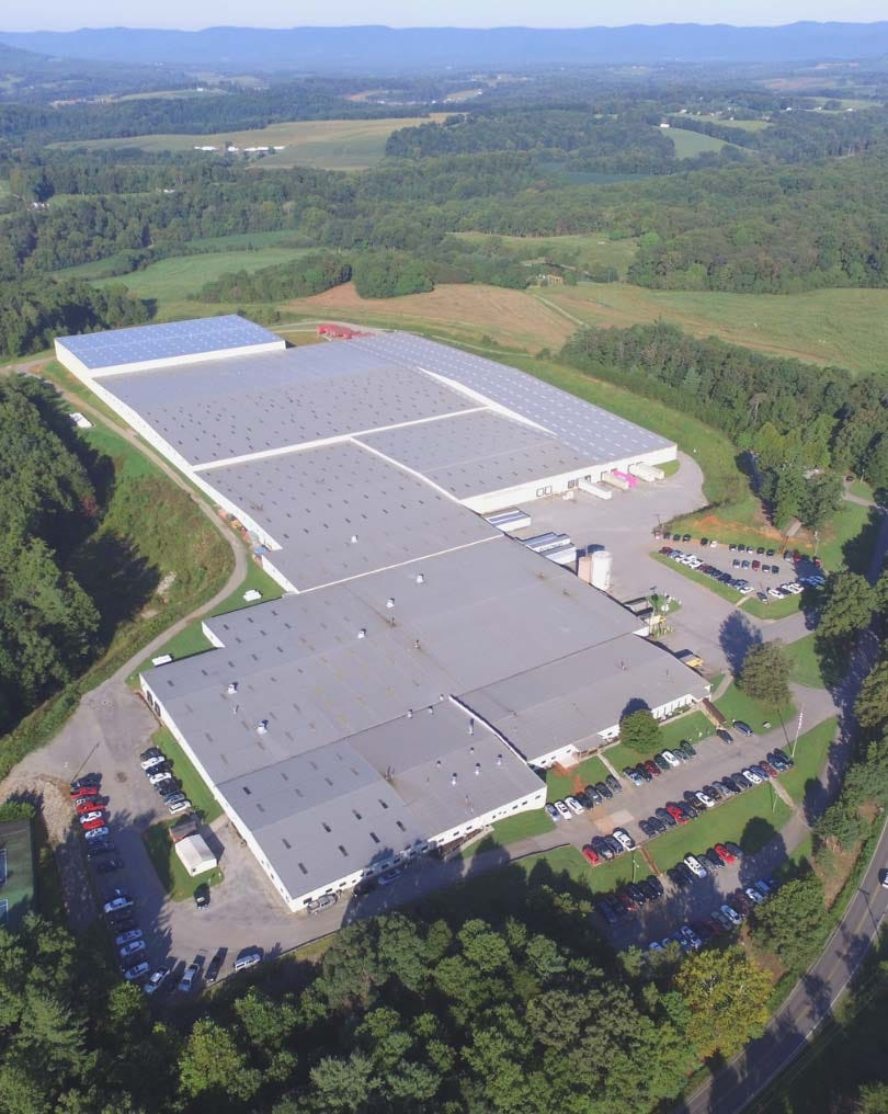 An aerial view of the Uttermost plant and distribution center set in the wooded hills around Rocky Mount, Virginia