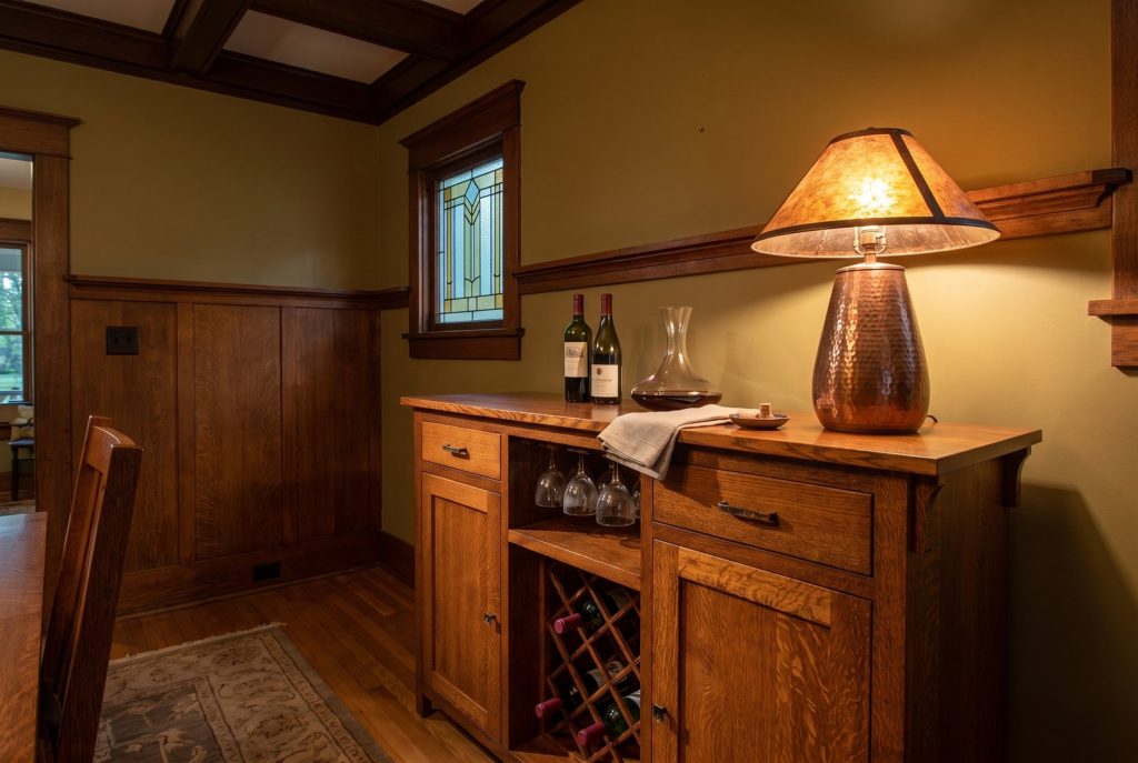 A quarter-sawn white oak wine buffet with a stemware rack and wine lattice in a Craftsman dining room.